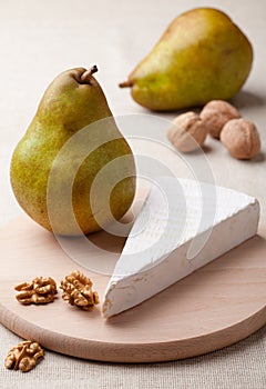 Green pears, cheese brie, cores of walnuts