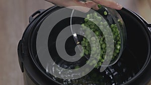 Green peas in bowl shift in water close-up