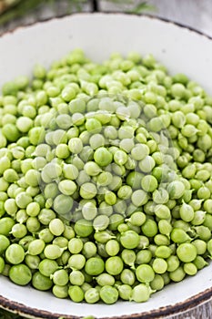 Green peas in a bowl top view
