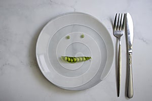 Green peas on an empty plate lifestyles