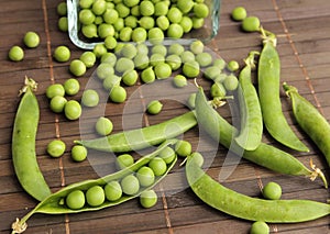 Green peas pods on table