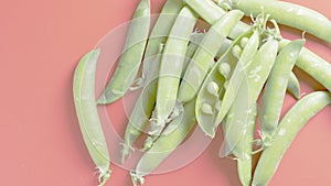 Green peas on a red background photo