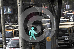 Green pedestrian traffic light on the street