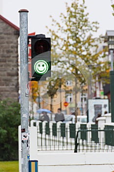 Green pedestrian traffic lights with emoji