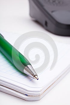 The green pen and notebook