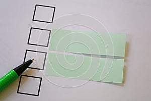 Green pen pointing empty checkbox and have blank paper note.