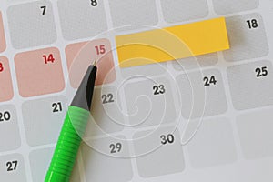 Green pen points to a fifteen number of calendar and have blank