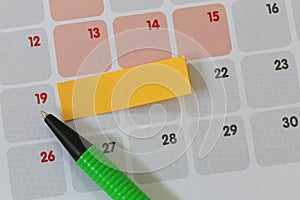 Green pen points to a nineteen number of calendar and have blank