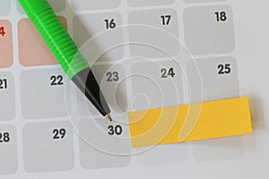 Green pen points to a thirty number of calendar and have blank y