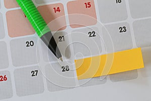 Green pen points to a twenty eight number of calendar and have b