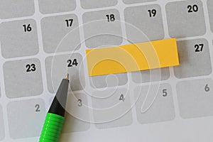 Green pen points to a Twenty-four number of calendar and have bl