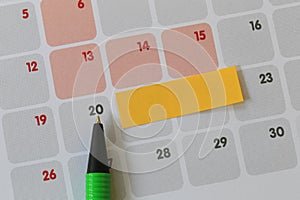 Green pen points to a twenty number of calendar and have blank y