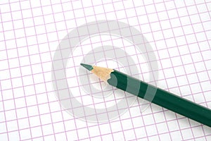 Green pencil on notebook