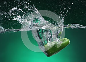 Green pepper falling into water