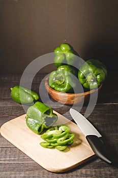 green pepper paprika in a wooden bowl and cut on a wooden board/green pepper paprika in a wooden bowl and cut on a wooden board on