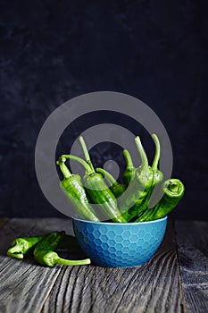 Green peppers on wooden background