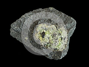 Green peridote olivine in dark basalt rock