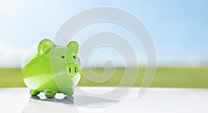 Green piggy bank against blue sky background savings, accounting, banking and business account or sustainable and environmentally