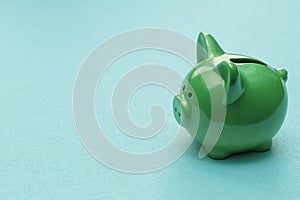 Green piggy bank on a colored background