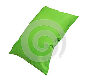 Green pillow at hotel or resort room isolated on white background with clipping path. Concept of confortable and happy sleep in photo