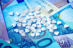 Green pills on the background of euro bills. The concept of the expensive cost of healthcare