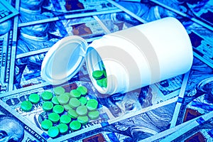 Green pills on the background of one hundred dollar bills. The concept of the expensive cost of healthcare or financing medicine.