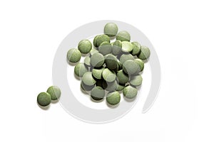 Green pills on a white background isolate, dietary supplement with plant leaf extract, detox, immunity, anti-age superfood