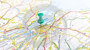 A green pin stuck in Edinburgh on a map of Scotland