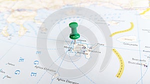 A green pin stuck in the island of lemnos limnos on a map of Greece
