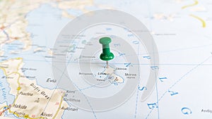 A green pin stuck in the island of skyros skiros on a map of Greece photo