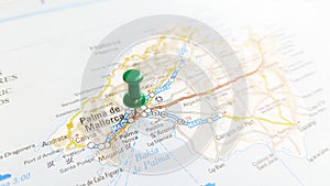 A green pin stuck in the island of Mallorca on a map of Spain photo