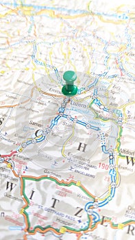 A green pin stuck in luzern Lucerne on a map of Switzerland portrait