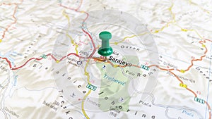 A green pin stuck in Sarajevo on a map of Bosnia and Herzegovina