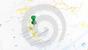 A green pin stuck in South Uist Island on a map of Scotland