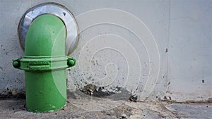 Green pipe on the wall