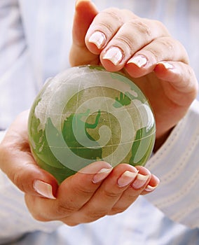 Green planet in women's hands. photo