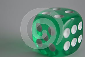 Green plastic arcylic d6 six sided die dice close up variable focus