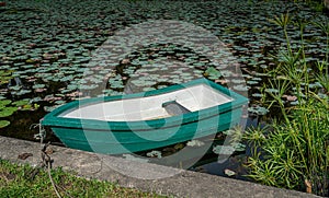 Green plastic boat on the pond