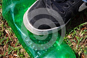 Green plastic bottle crushed.