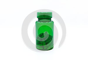 Green plastic bottle of pills or capsules isolated on white background. Healthy food, herbs, container object and Medicine