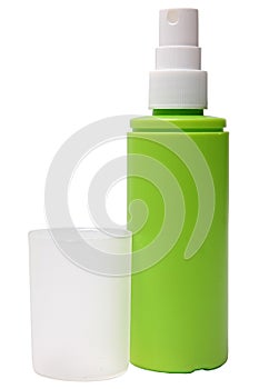 Green plastic bottle of spray isolated on a white photo