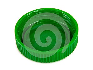 Green plastic ecological cap of bottle macro isolated on the white
