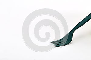 Green plastic forks on white