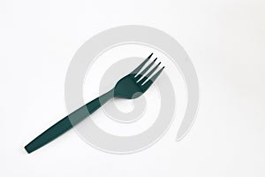 Green plastic forks on white