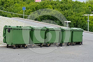 Green plastic garbage containers installed along in the Park. The concept of separate garbage collection