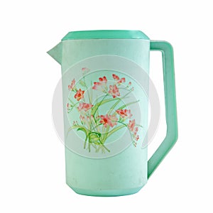 Green plastic jug with floral pattern isolated
