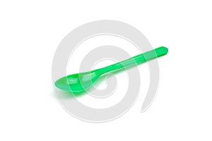 Green plastic spoon isolated on white background