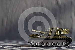 Green Plastic Tank Toy on dark background