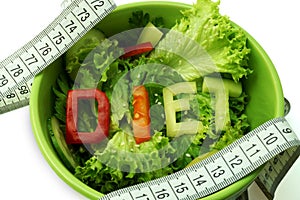 Green plate with word diet composed of slices