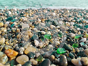 Green polished sea glass stones clam vacation holiday vacation sea shore background